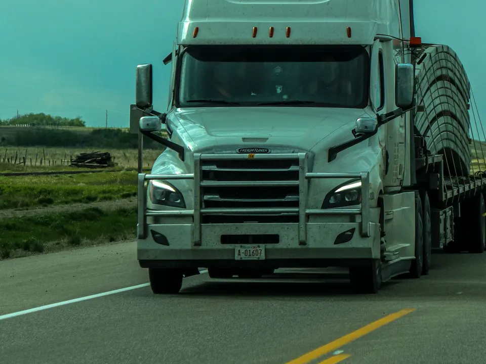 Cargo truck travelling on a highway under a blue sky